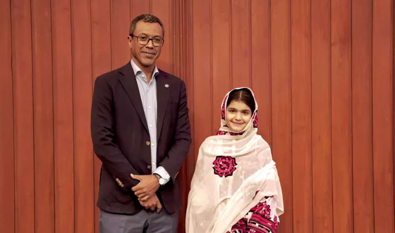 In this handout photo, released by UNICEF Pakistan on February 8, 2025, UNICEF Representative in Pakistan Abdullah A. Fadil gestures for a photograph with 14-year-old Pakistani girl Zunaira Qayyum, who hails from Hub district in Balochistan, in Islamabad, following her appointment as the Youth Advocate for Climate Action and Girls Empowerment in the country. (Photo courtesy: UNICEF)
