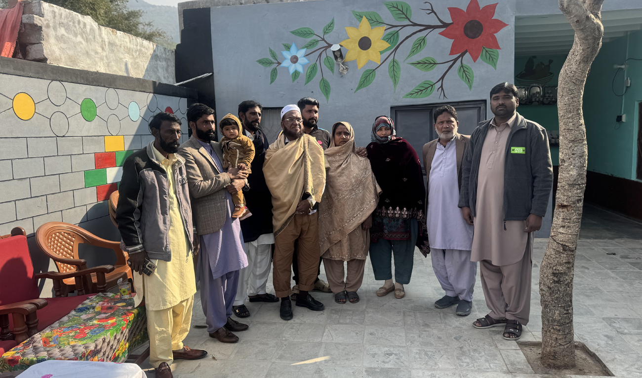 This photo, taken on January 30, 2025, shows Bangladeshi citizen Iftikhar Hussain (4L), separated by war, gestures with his family members following a reunion after over 50 years in a Pakistani village in Chakwal district on January 30, 2025. (AN Photo)