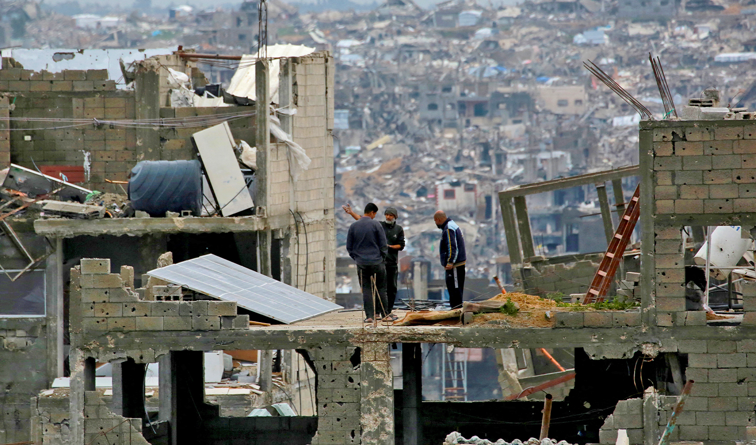 Palestinian men inspect the damage in a destroyed building in Jabalia in the northern Gaza Strip on February 6, 2025, during a truce in the war between Israel and Hamas. (AFP)
