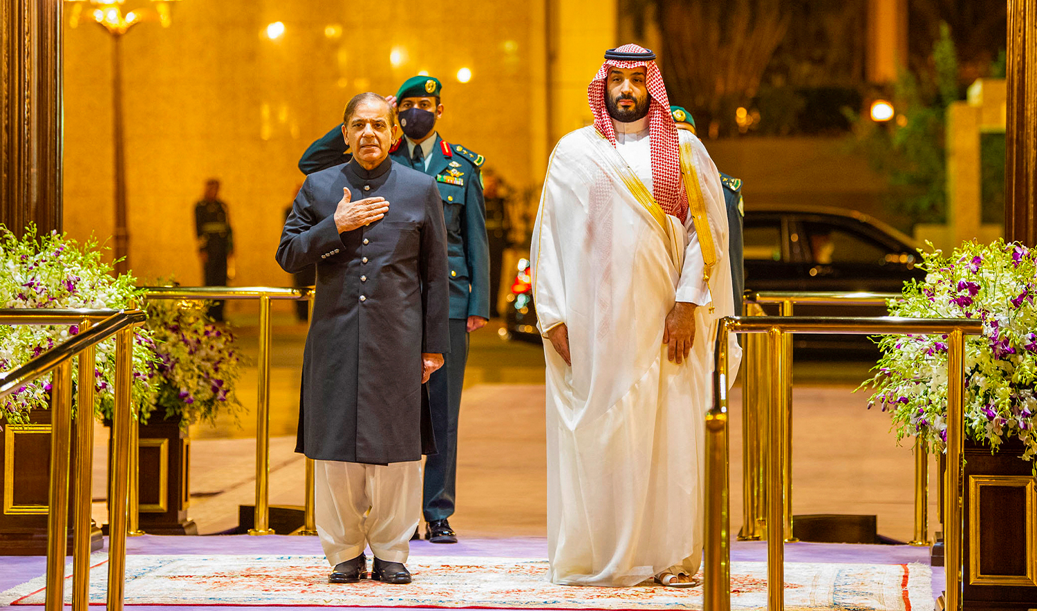 A handout picture provided by the Saudi Royal Palace shows Saudi Arabia's Crown Prince Mohammed Bin Salman (R) welcoming Pakistani Prime Minister Shehbaz Sharif in Jeddah on April 30, 2022. (AFP/File)