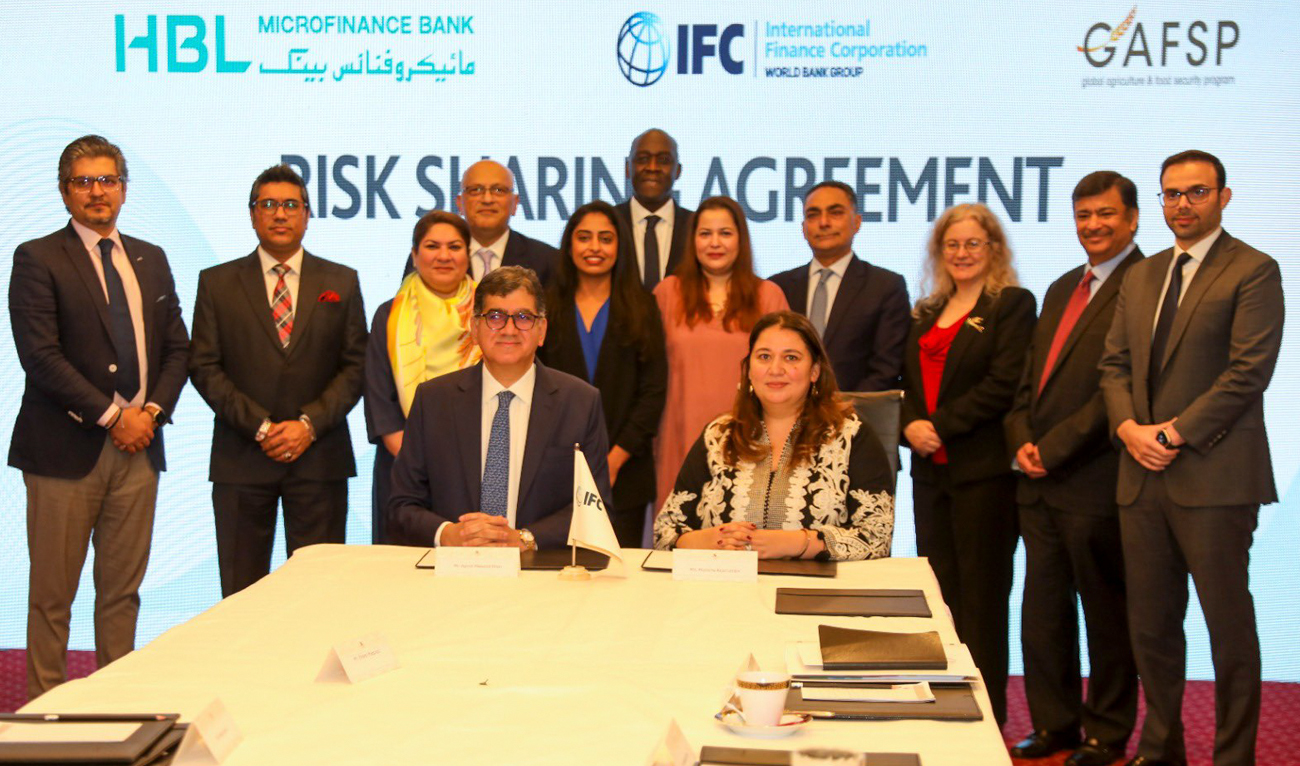 Officials gesture for a group photograph during the signing of a Risk Sharing Agreement between Pakistan’s HBL Microfinance Bank and the International Finance Corporation in Lahore on February 13, 2025. (Photo courtesy: Handout/Microfinance Bank)