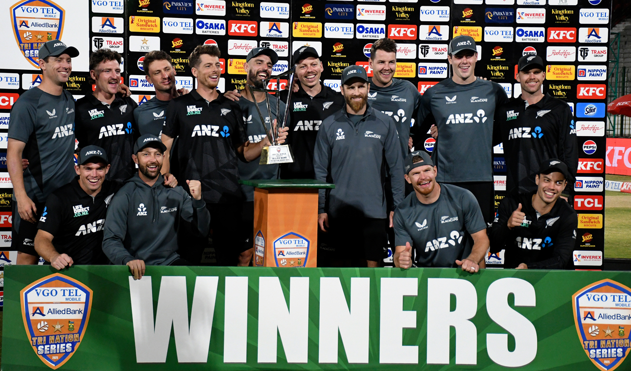 New Zealand’s players pose for photo with trophy after winning the tri-series final against Pakistan, in Karachi on February 14, 2025. (AP)