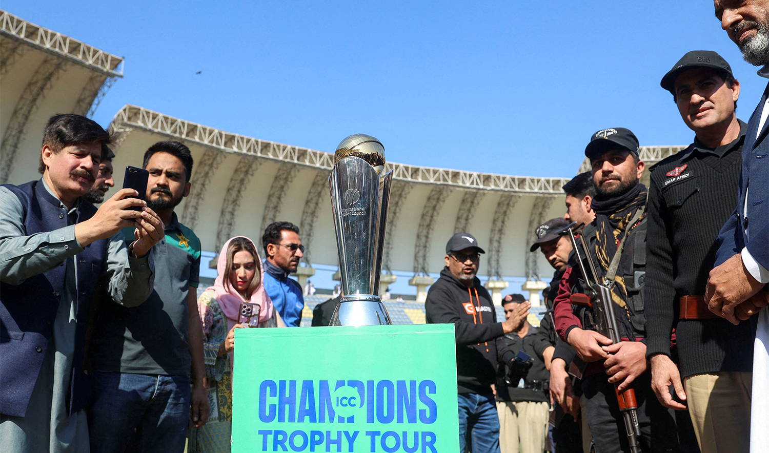 People with their mobile phones take photos of the ICC Champions trophy, during a ceremony at the Arbab Niaz Cricket Stadium in Peshawar, Pakistan, on February 6, 2025. (REUTERS/File)
