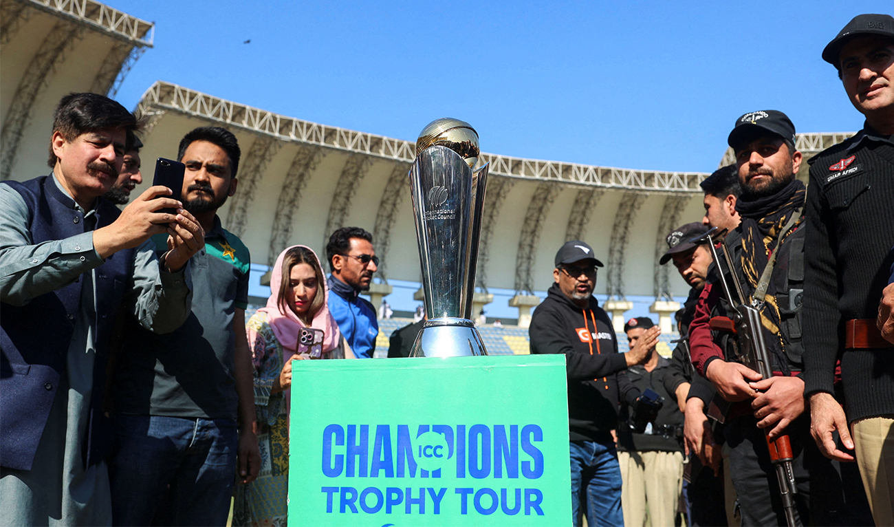 People with their mobile phones take photos of the ICC Champions trophy, during a ceremony at the Arbab Niaz Cricket Stadium in Peshawar, Pakistan, on February 6, 2025. (Reuters/File)