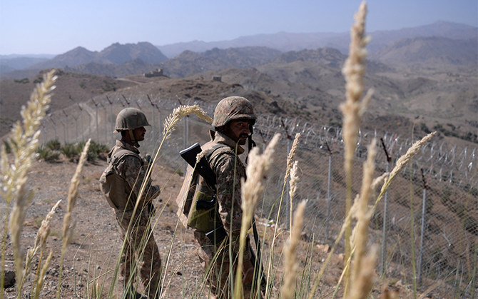 Pakistani soldiers keep vigil next to a newly fenced border fencing along Afghan border at Kitton Orchard Post in Pakistan's North Waziristan tribal agency on October 18, 2017. (AFP/File)