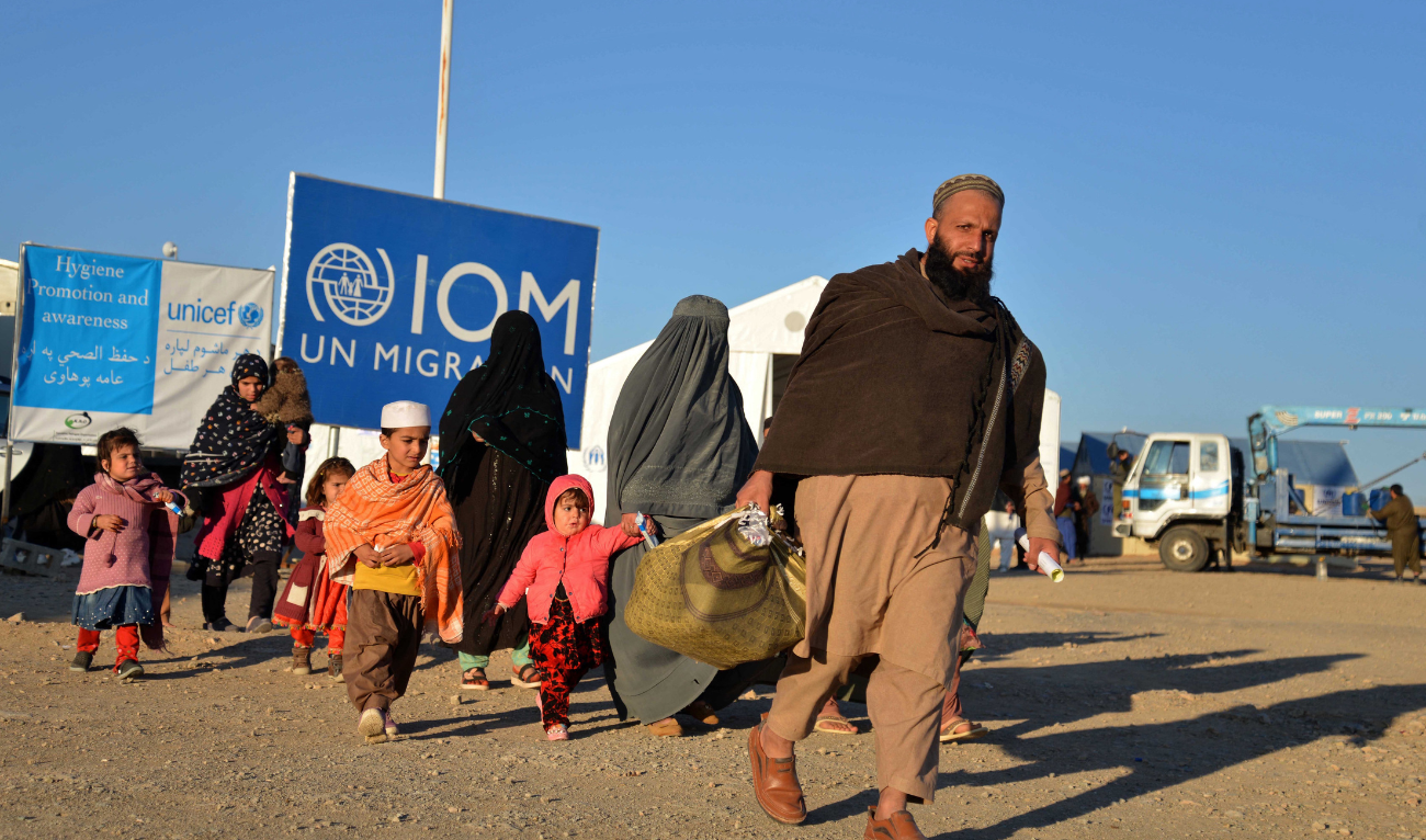 Afghan refugees walk at a registration centre, upon their arrival from Pakistan in Takhta Pul district of Kandahar province on December 18, 2023. (AFP/File)