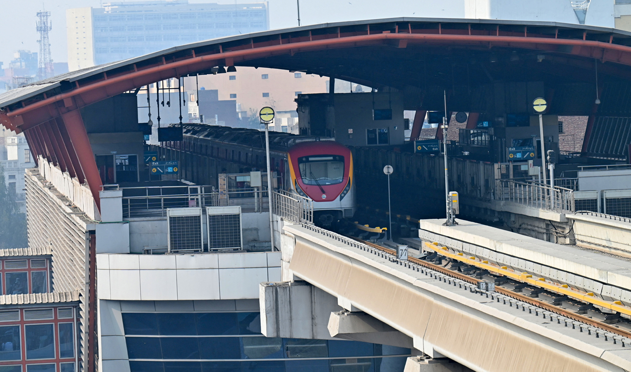 An orange line metro train (OLMT) stands parked at a station in Lahore on January 23, 2023. (AFP/File)