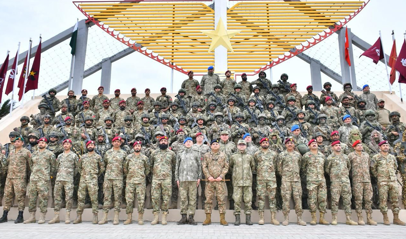 In this handout photo, taken and released by the Inter-Services Public Relations (ISPR) on February 20, 2025, participating troops from Pakistan and Türkiye gesture for a group photograph as they conclude joint military exercise “Ataturk-XIII” at the Special Operations School in Cherat, Pakistan. (Photo courtesy: ISPR)