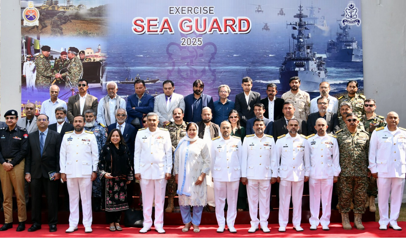 The handout photograph released by the Pakistan Navy on February 24, 2025, shows Naval officials and representatives of National stakeholders pose for a group photo after the opening brief of the Sea Guard-2025 exercise in Karachi. (DG-PR Pakistan Navy)