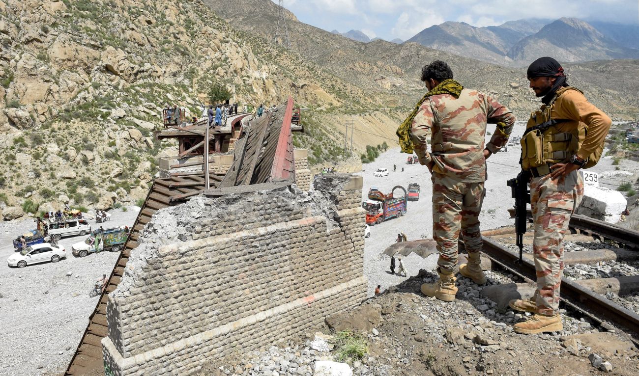 Security personnel inspect a collapsed railway bridge the morning after a blast by separatist militants at Kolpur in Bolan district, Balochistan province on August 27, 2024. (AFP/File)