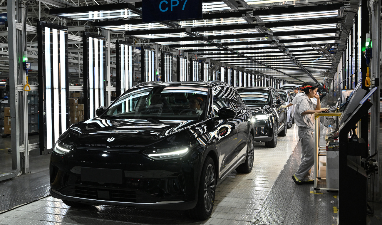 Employees work on an electric vehicle (EV) production line at the Leapmotor factory in Jinhua, China's eastern Zhejiang province on September 18, 2024. (AFP/File)