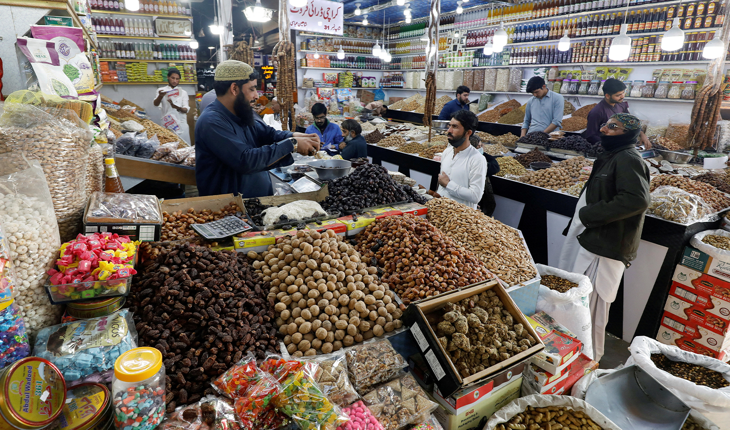 People buy dry fruits at a market in Karachi, Pakistan, on February 1, 2023. (REUTERS/File)