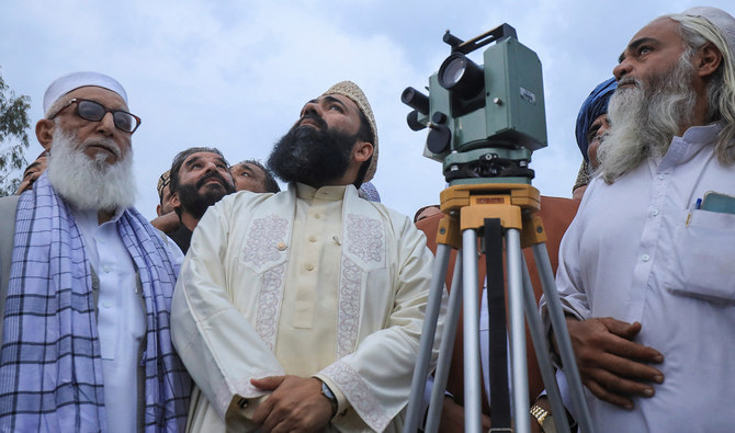 Members of Pakistan’s moon sighting committee check weather as they gather to look for the new moon that will mark the start of Ramadan, from the office of the administrator Auqaf building in Charsadda district of Khyber Pakhtunkhwa, Pakistan, on March 22, 2023. (REUTERS/File)