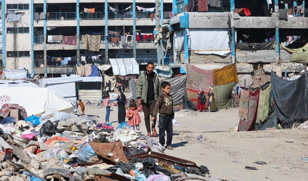 People walk inside a school housing displaced Palestinians in Jabalia in the northern Gaza Strip on February 27, 2025. (AFP)