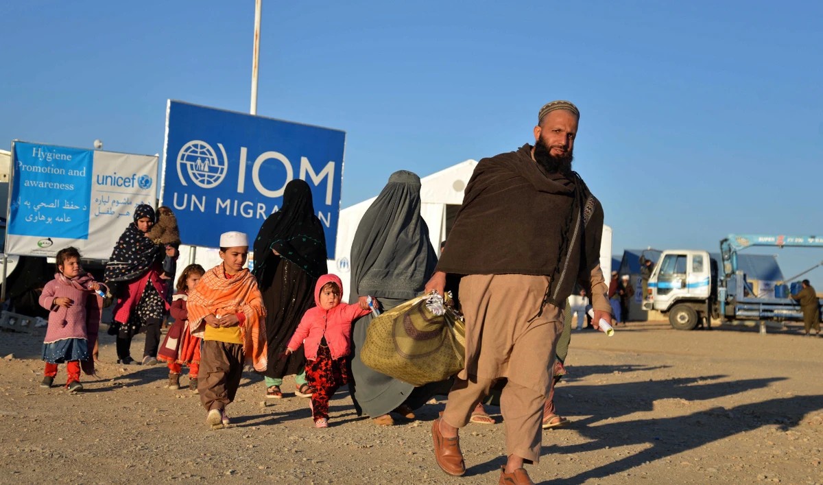 Afghan refugees walk at a registration centre, upon their arrival from Pakistan in Takhta Pul district of Kandahar province on December 18, 2023. (AFP/File)