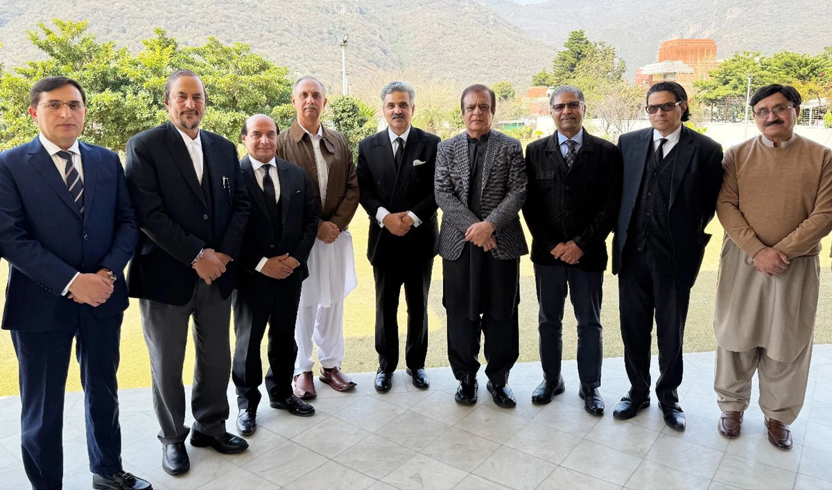 In this handout photo, taken and released by the Supreme Court of Pakistan on February 21, 2025, Pakistan Chief Justice Yahya Afridi (5R) gestures for a group photograph with the Pakistan Tehreek-e-Insaf and opposition leaders following a meeting at the Chief Justice House in Islamabad. (Photo courtesy: Handout/SCP)