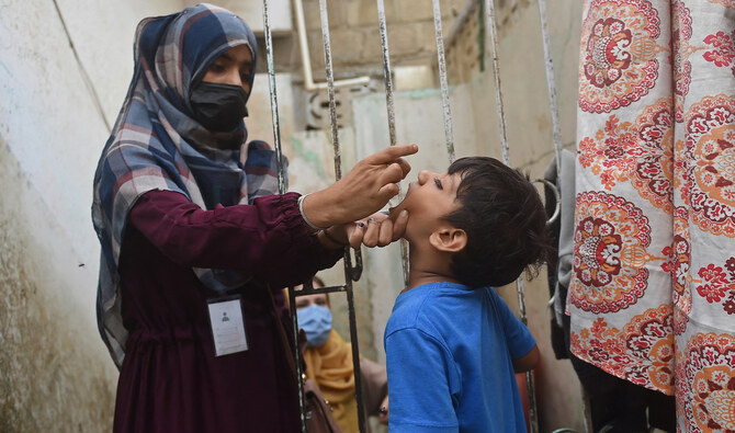 A health worker administers polio drops to a child during a door-to-door vaccination campaign in Karachi, Pakistan, on August 7, 2023. (AFP/File)