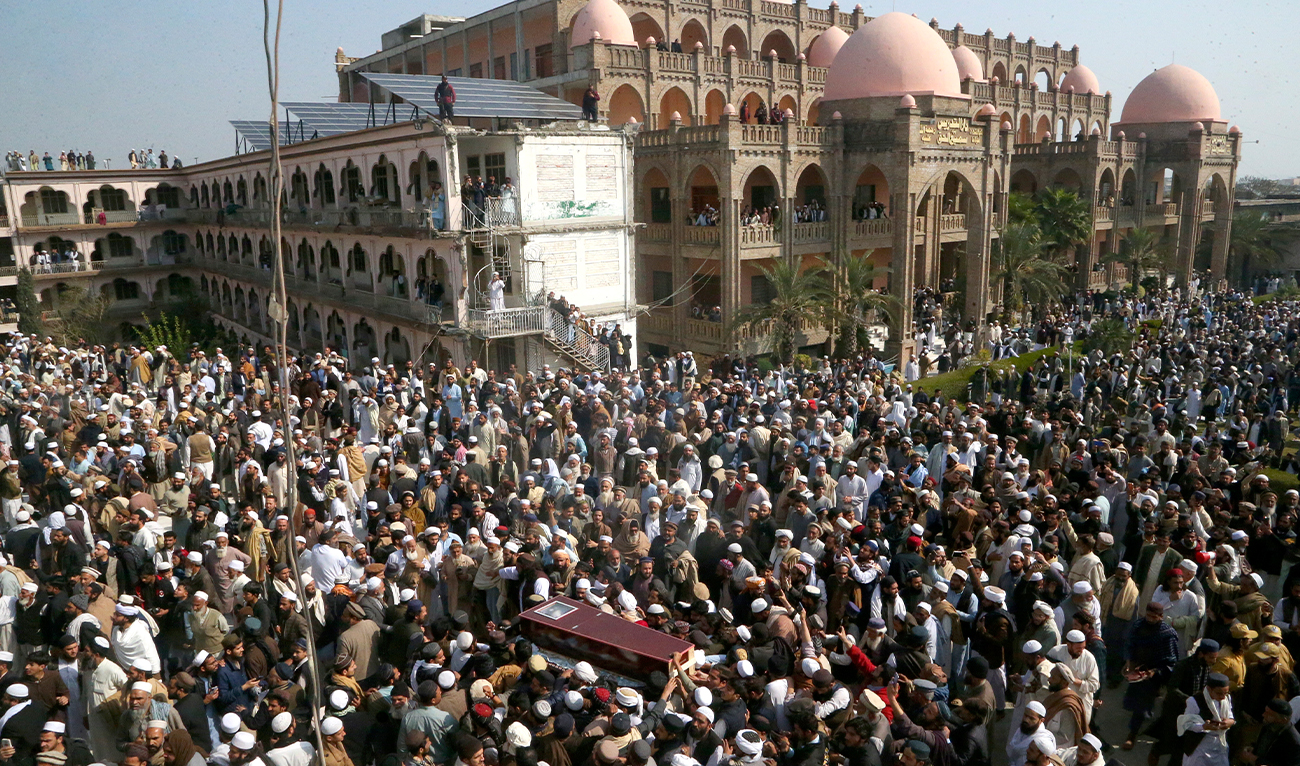 Mourners carry the casket of senior cleric Maulana Hamidul Haq, who was killed in a suicide bomb attack at a local seminary on Friday, during his funeral prayer in Akora Khattak, Pakistan, on March 1, 2025. (AP)