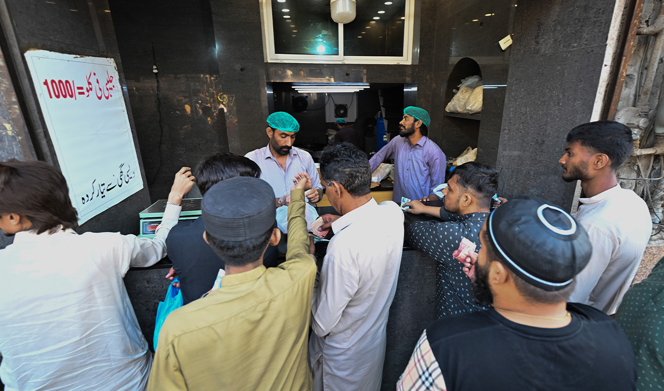 People buying from vendor at Burns road Karachi, Pakistan on March 05, 2025 (Reuters/File)