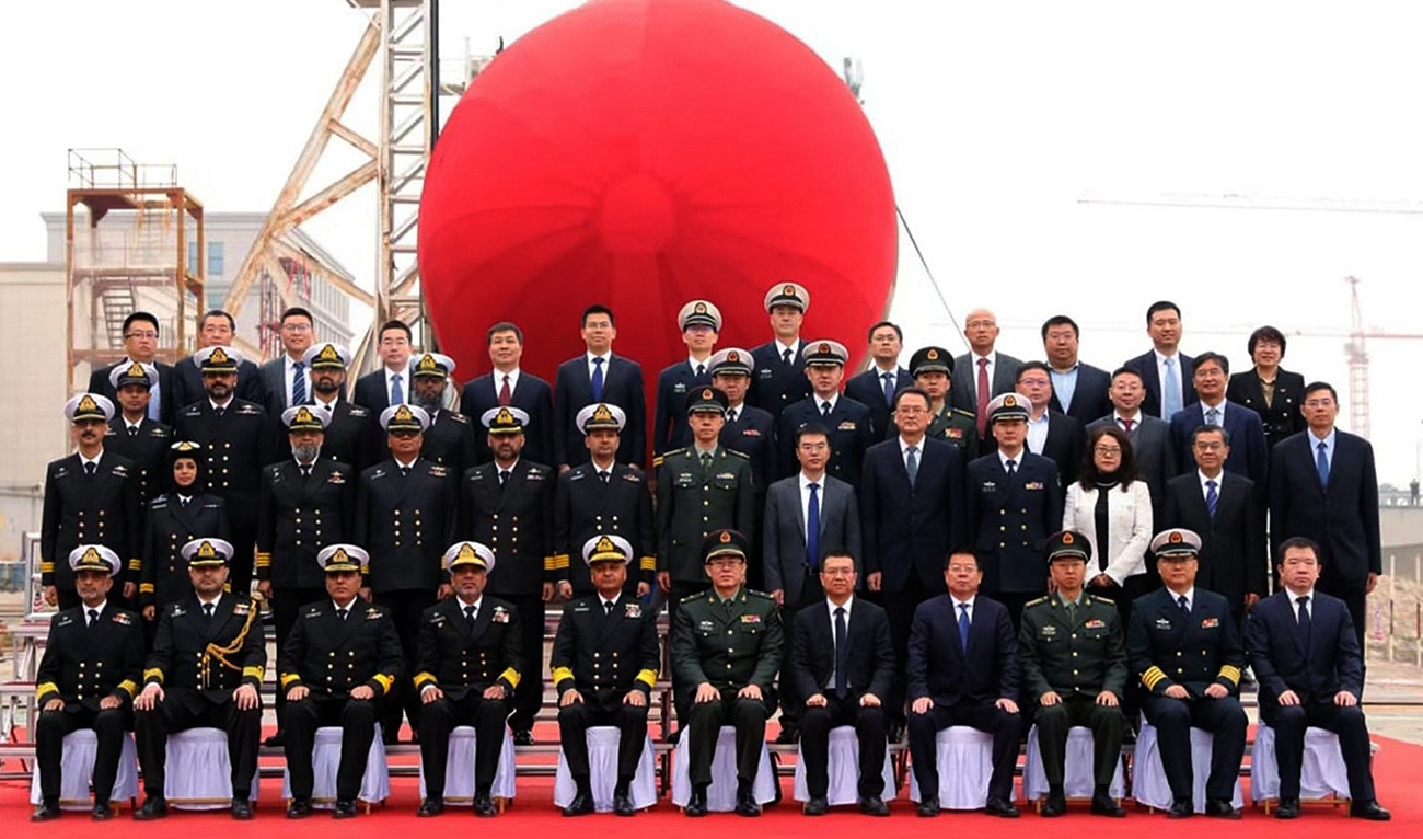 In this handout photo, released by Pakistan Navy on March 15, 2025, Pakistan’s Vice Chief of the Naval Staff Vice Admiral Ovais Ahmed Bilgrami gestures for a group photography with officials from Pakistan Navy and China Shipyard during the launching ceremony of second HANGOR Class Submarine at Wuhan, China. (Handout/Pakistan Navy)