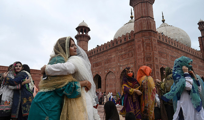 Muslim devotees greet each other after offering Eid prayers at the historical Badshahi Mosque during the Eid al-Adha or the 'Festival of Sacrifice, in Lahore on July 21, 2021. (AFP/FILE)