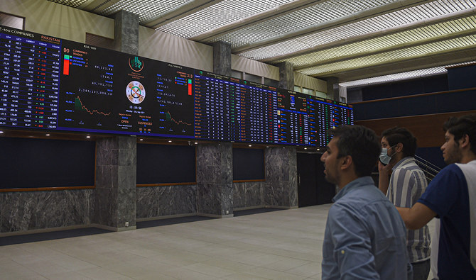 Stockbrokers watch an index board showing the latest share prices during a trading session at the Pakistan Stock Exchange (PSX) in Karachi on September 20, 2021. (AFP/File)
