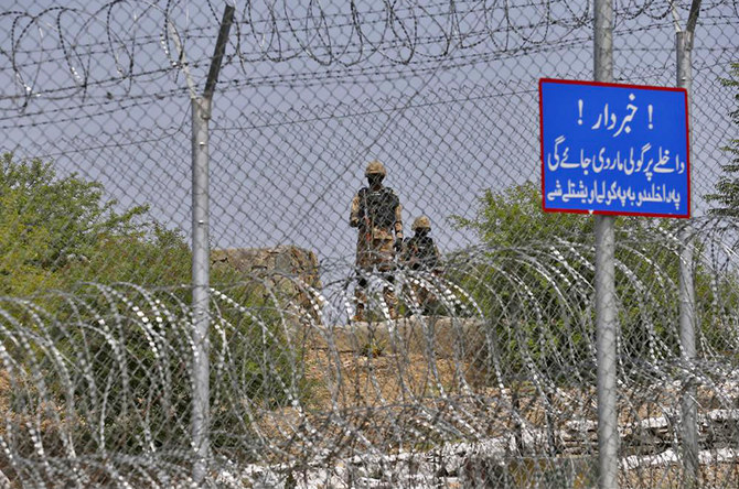 Pakistani troops patrol a fence along the Pak-Afghan border near Torkham in Khyber district on August 3, 2021. (AN Photo)