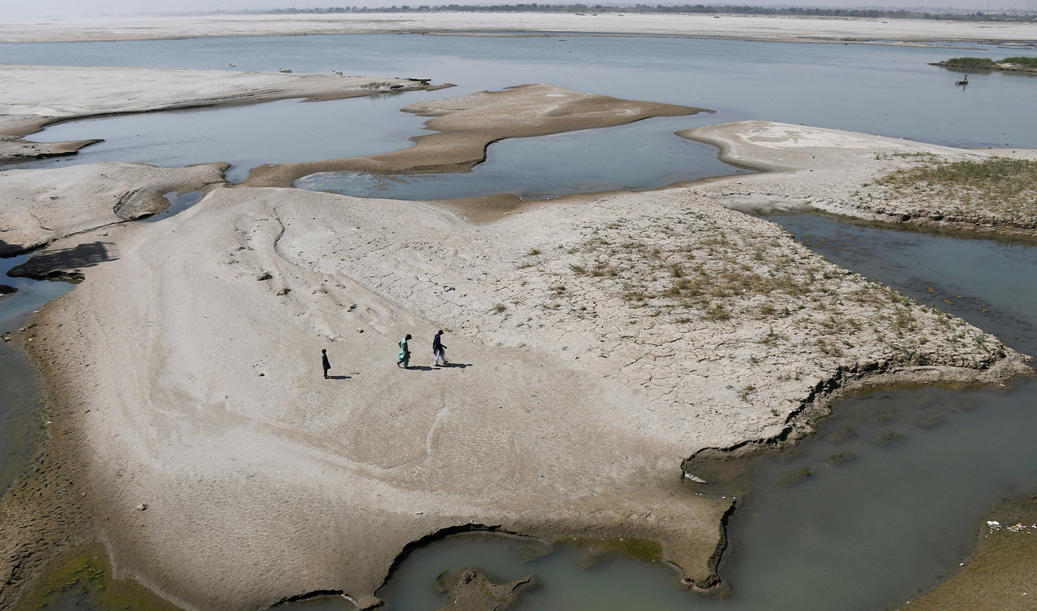 eople walk on the dry patch of the Indus River, in Jamshoro, Pakistan, on March 15, 2025. (REUTERS)