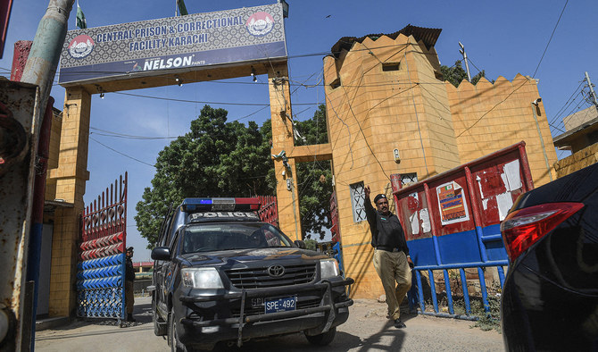 A Pakistani policeman gestures as a police vehicle leaves the Central Prison in Karachi on September 22, 2020. (AFP/File)