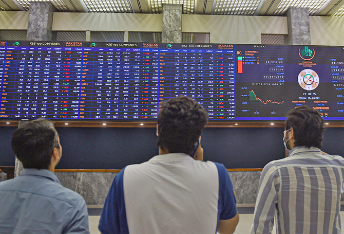 Stockbrokers watch an index board showing the latest share prices during a trading session at the Pakistan Stock Exchange (PSX) in Karachi, Pakistan, on September 20, 2021. (AFP/File)