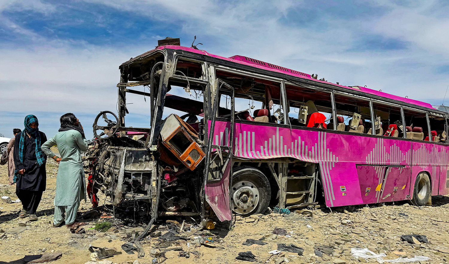 Bystanders look at the wreckage of a bus in Noshki town of Balochistan province on March 17, 2025. (AFP/File)