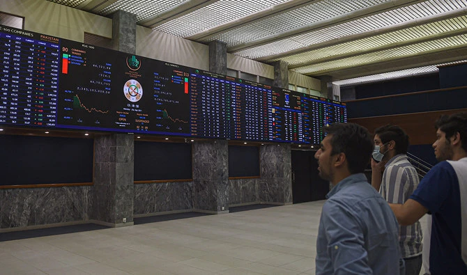Stockbrokers watch an index board showing the latest share prices during a trading session at the Pakistan Stock Exchange (PSX) in Karachi on September 20, 2021. (AFP/File)