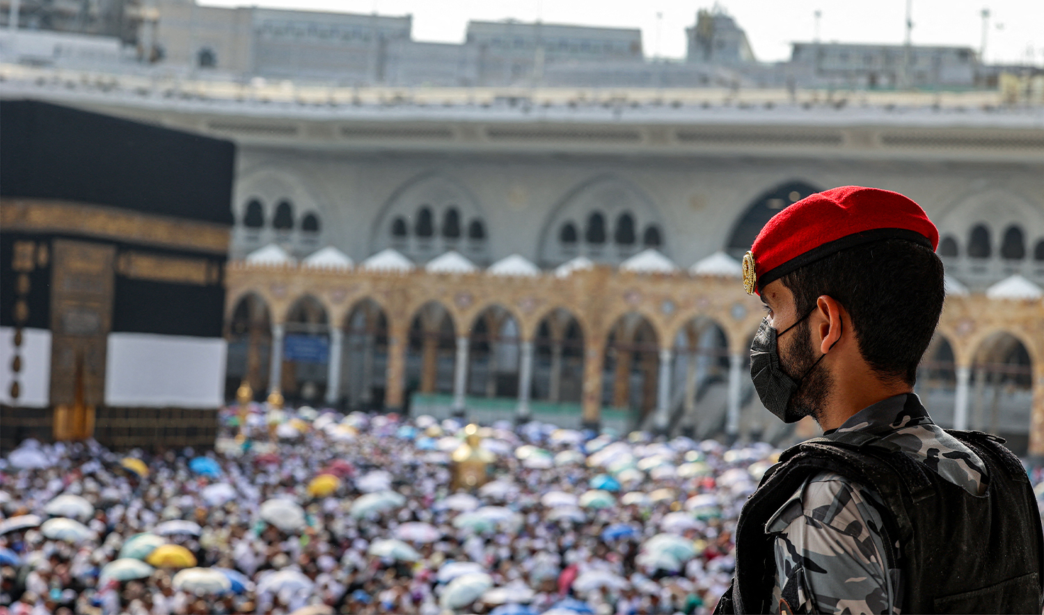 A Saudi security officer watches as Muslim pilgrims perform the farewell circumambulation or "tawaf", circling seven times around the Kaaba, Islam's holiest shrine, at the Grand Mosque in the holy city of Makkah on June 18, 2024. (AFP/File)