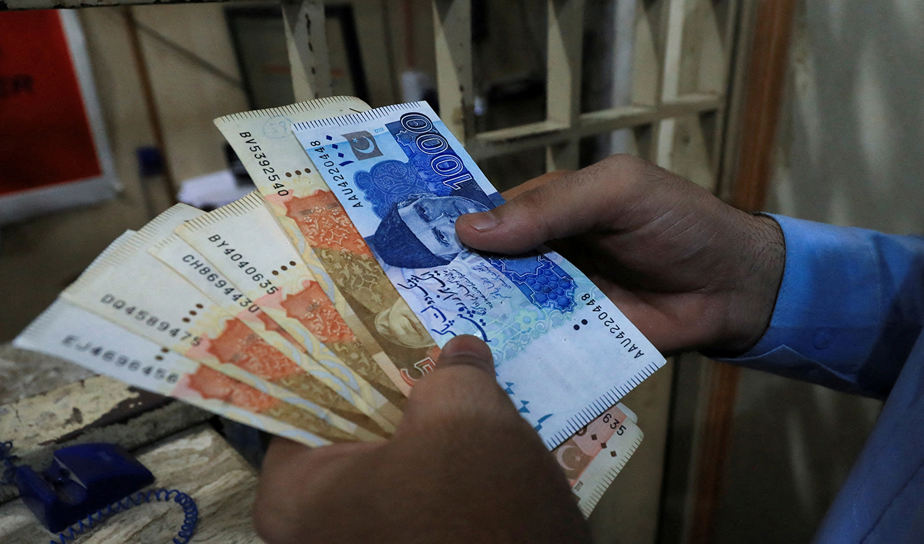 A man counts Pakistani rupee notes at a currency exchange shop in Peshawar, Pakistan September 12, 2023. (REUTERS/File)