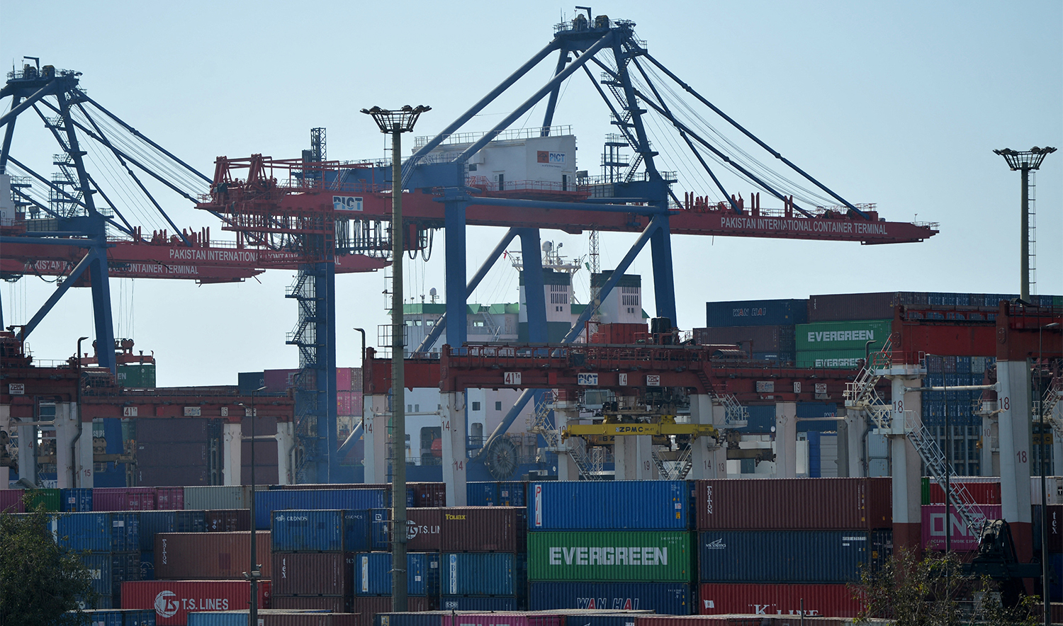 In this picture taken on January 11, 2023, shipping containers are seen placed under cranes at the Karachi sea port. (AFP/File)