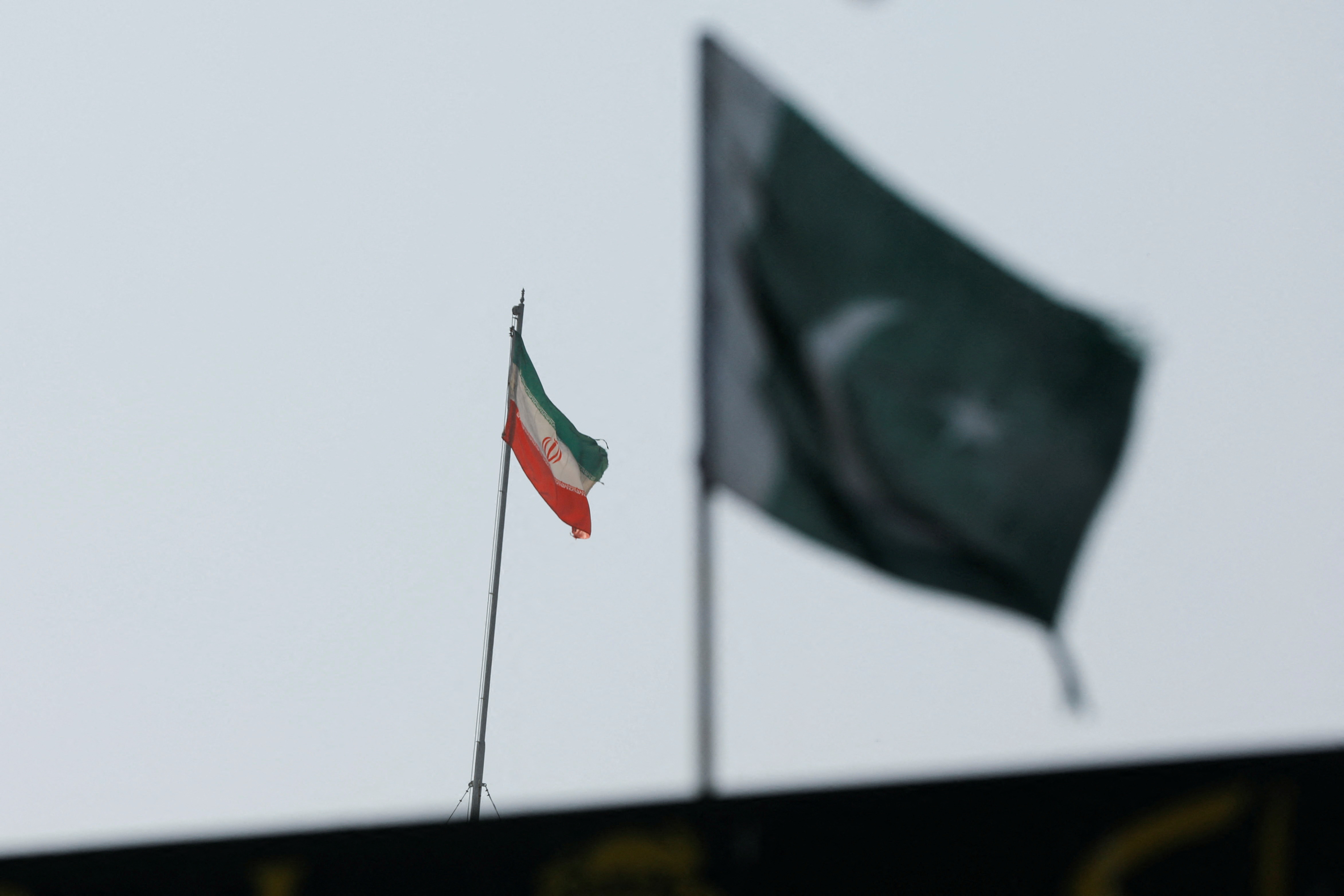 The flag of Iran is seen over its consulate building, with Pakistan’s flag in the foreground, after the Pakistani foreign ministry said the country conducted strikes inside Iran targeting separatist militants, two days after Tehran said it attacked Israel-linked militant bases inside Pakistani territory, in Karachi, Pakistan, on January 18, 2024. (REUTERS/File)