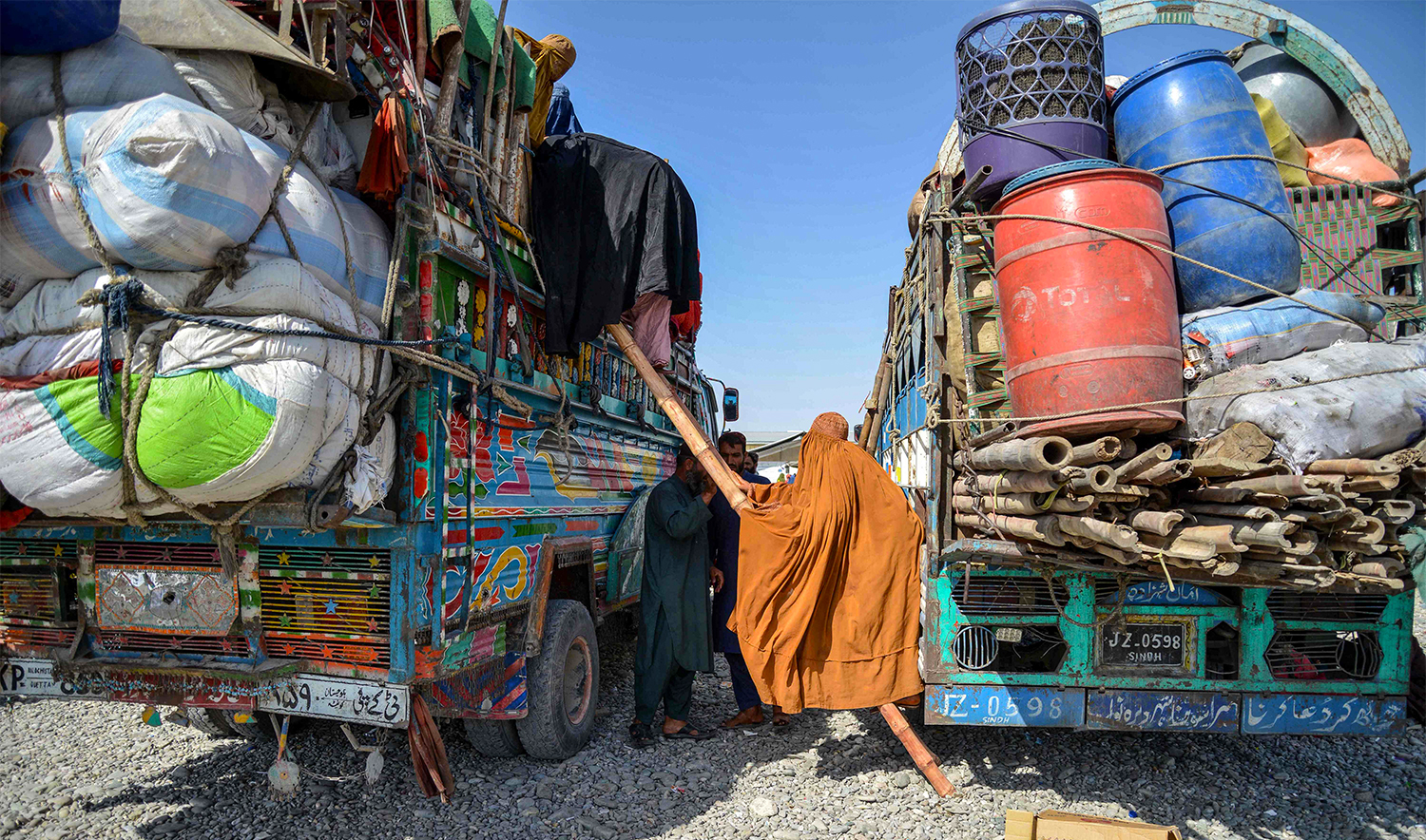 Afghan refugee women climb down from a truck upon their arrival from Pakistan at a registration centre in Takhta Pul district of Kandahar province on April 13, 2025. (AFP)