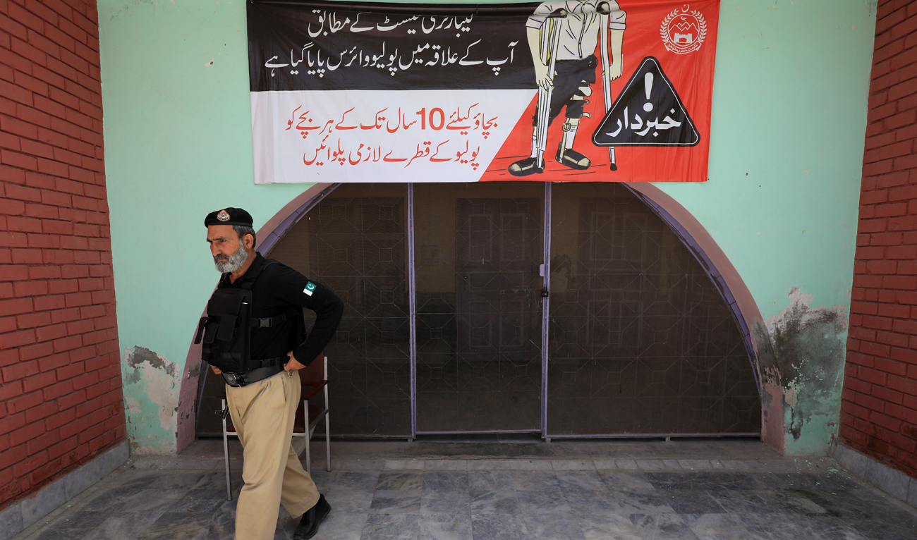 In this file photo, taken on April 26, 2019, a police officer walks outside a Polio Vaccination center in Peshawar, Pakistan. (REUTERS/File)