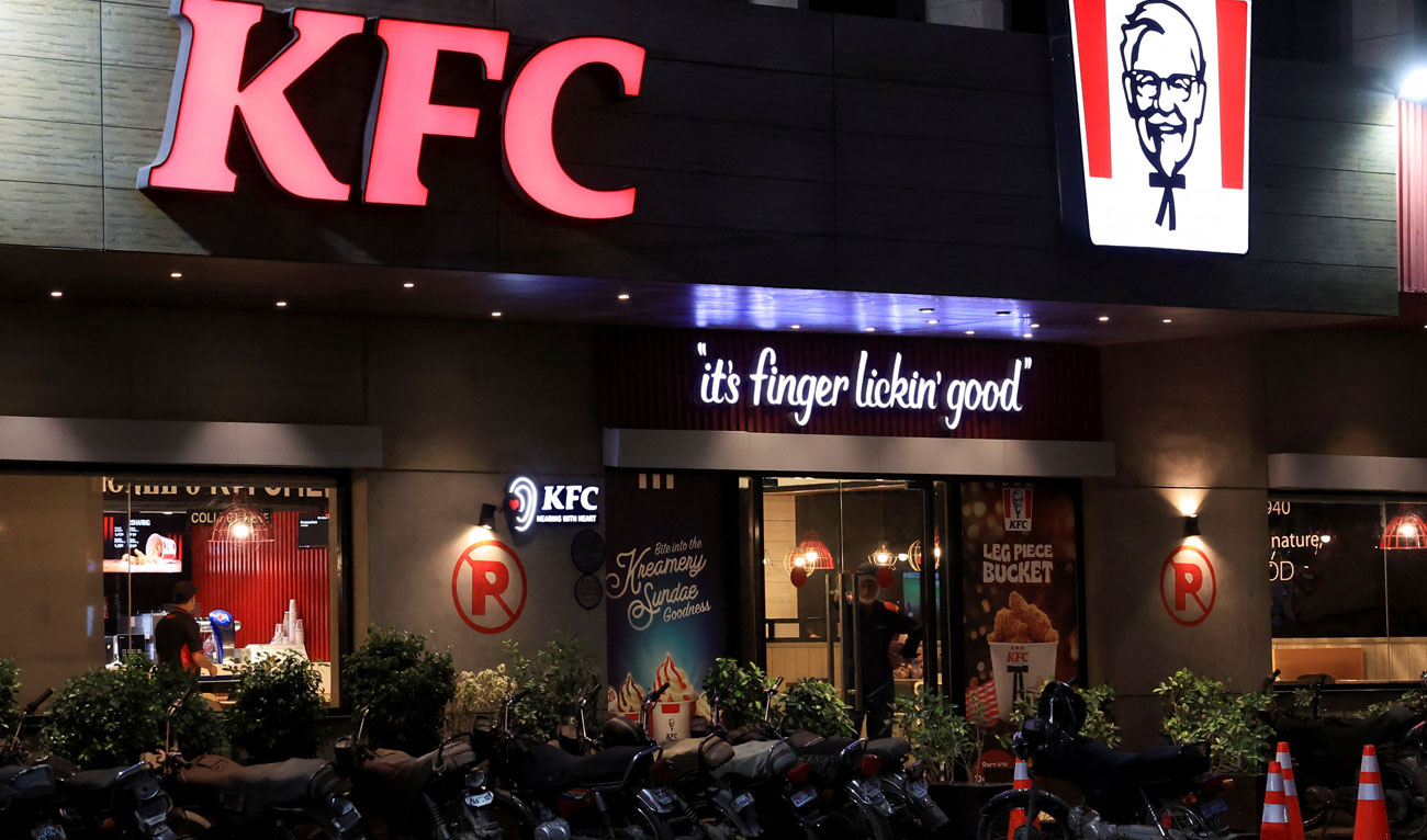 A security guard stands at the entrance of a Kentucky Fried Chicken (KFC) outlet in Karachi, Pakistan on April 16, 2025. (REUTERS)