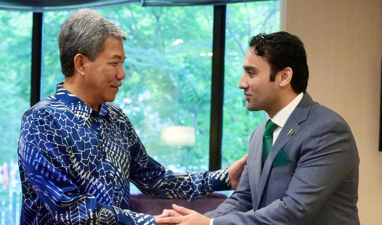 The handout photograph released by Pakistan’s Ministry of Finance on April 22, 2025, shows Malaysian Foreign Minister Mohamad bin Hajji Hasan (left) meets Bilal bin Saqib, head of the Pakistan Crypto Council (PCC), in Kuala Lumpur. (Photo Courtesy: Ministry of Finance Pakistan)