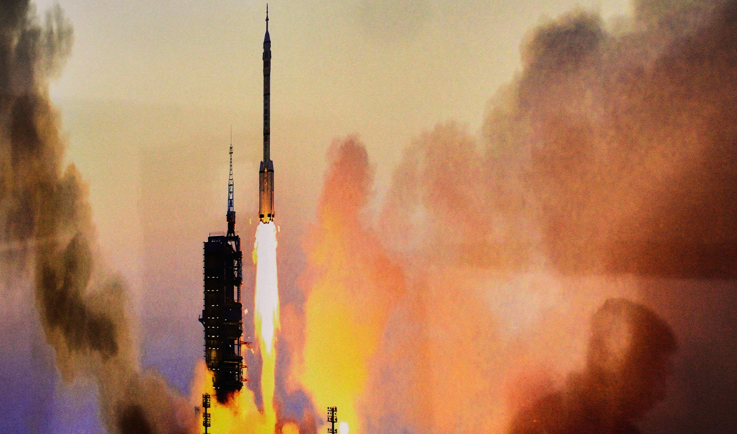 A staff member is reflected on a photo of a Shenzhou mission launch during a press conference by Lin Xiqiang, spokesperson of the China Manned Space Program and deputy director of the China Manned Space Agency, ahead of the Shenzhou-20 mission at the Jiuquan Satellite Launch Center in Jiuquan, northwestern China, on April 25, 2025. (AP)