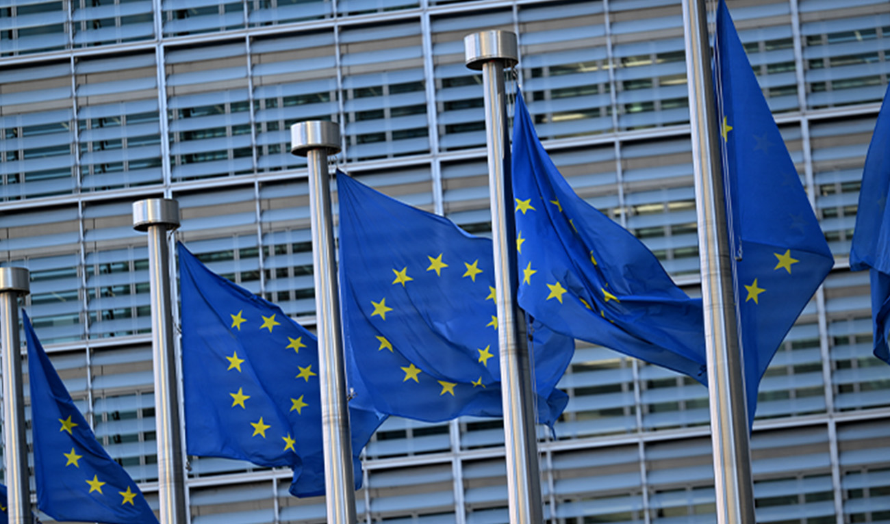 This photograph taken on March 19, 2025 shows European flags outside the EU headquarters in Brussels. (AFP/File)