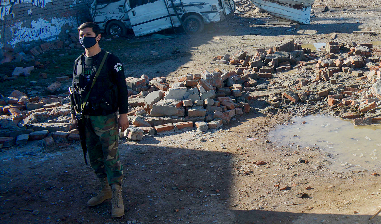 A security personnel stands guard near a detonated explosive-laden van at an army compound in Bannu, Pakistan, on March 5, 2025. (AFP/File)