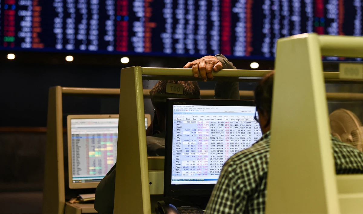 Stock brokers monitor share prices on computers during a trading session at the Pakistan Stock Exchange (PSX) in Karachi on February 12, 2024. (AFP/File)