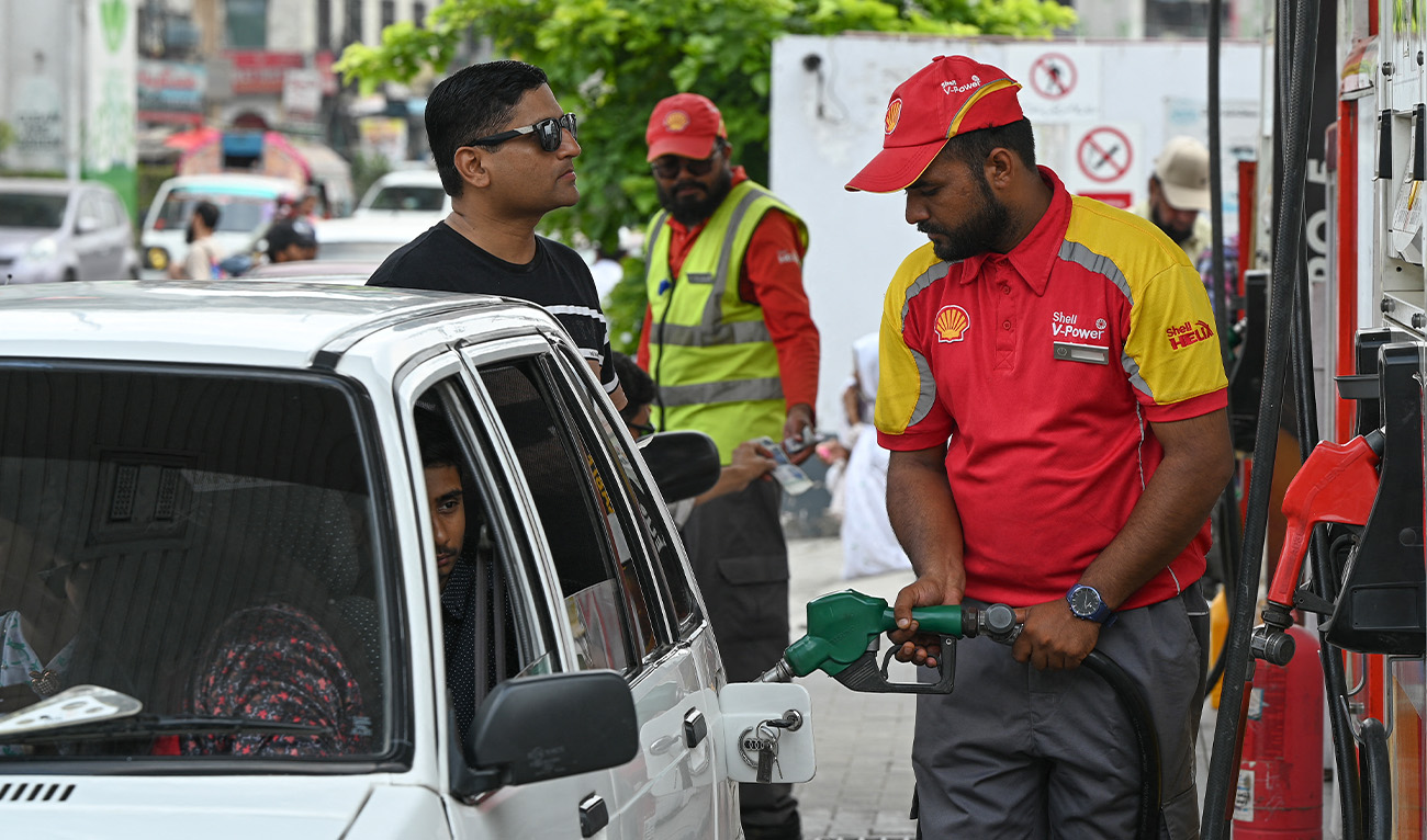 A worker pumps petrol in a car at a fuel station in Rawalpindi on July 16, 2023. (AFP/File)