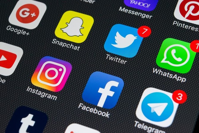 An Apple iPhone X with icons of social media facebook, instagram, twitter, snapchat applications on screen. (Shutterstock/File)