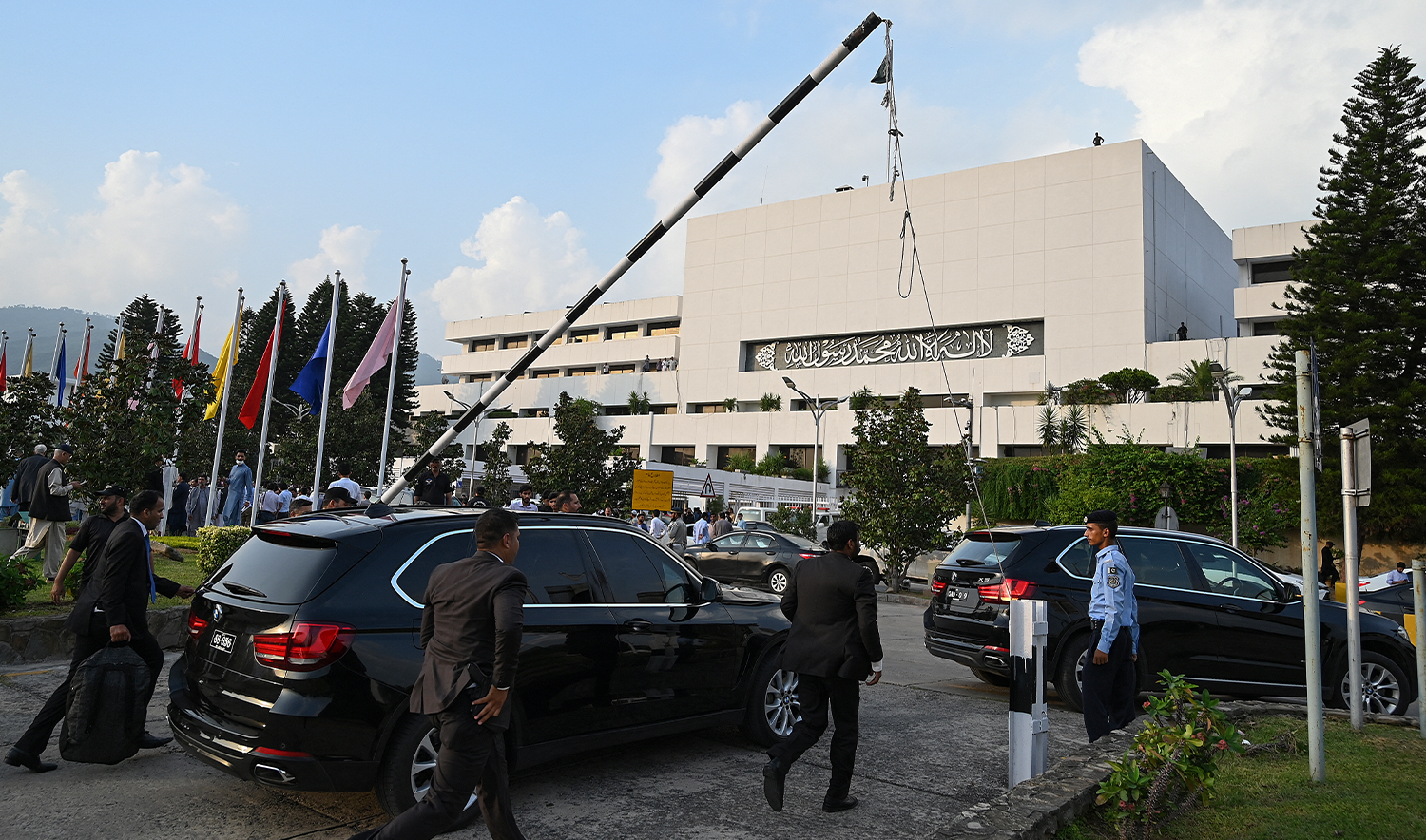 Security personnel escort a vehicle carrying Pakistan's Prime Minister Shehbaz Sharif as he leaves after attending current last session of National Assembly in Islamabad on August 9, 2023. (AFP/File)
