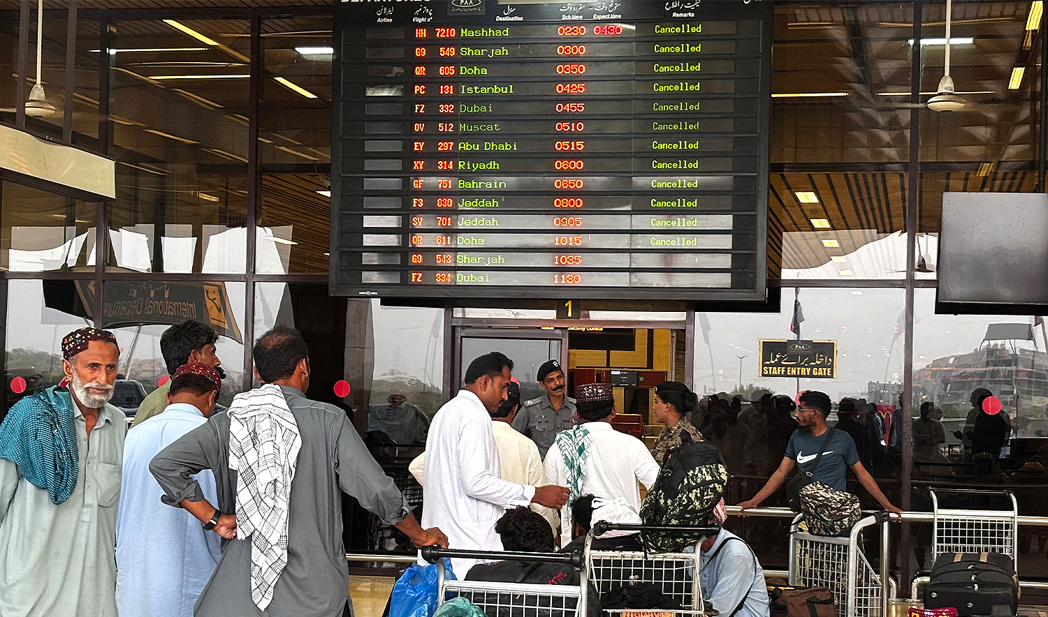 Passengers wait at Jinnah International Airport after all domestic and international flights were cancelled in Karachi on May 7, 2025. (AFP)