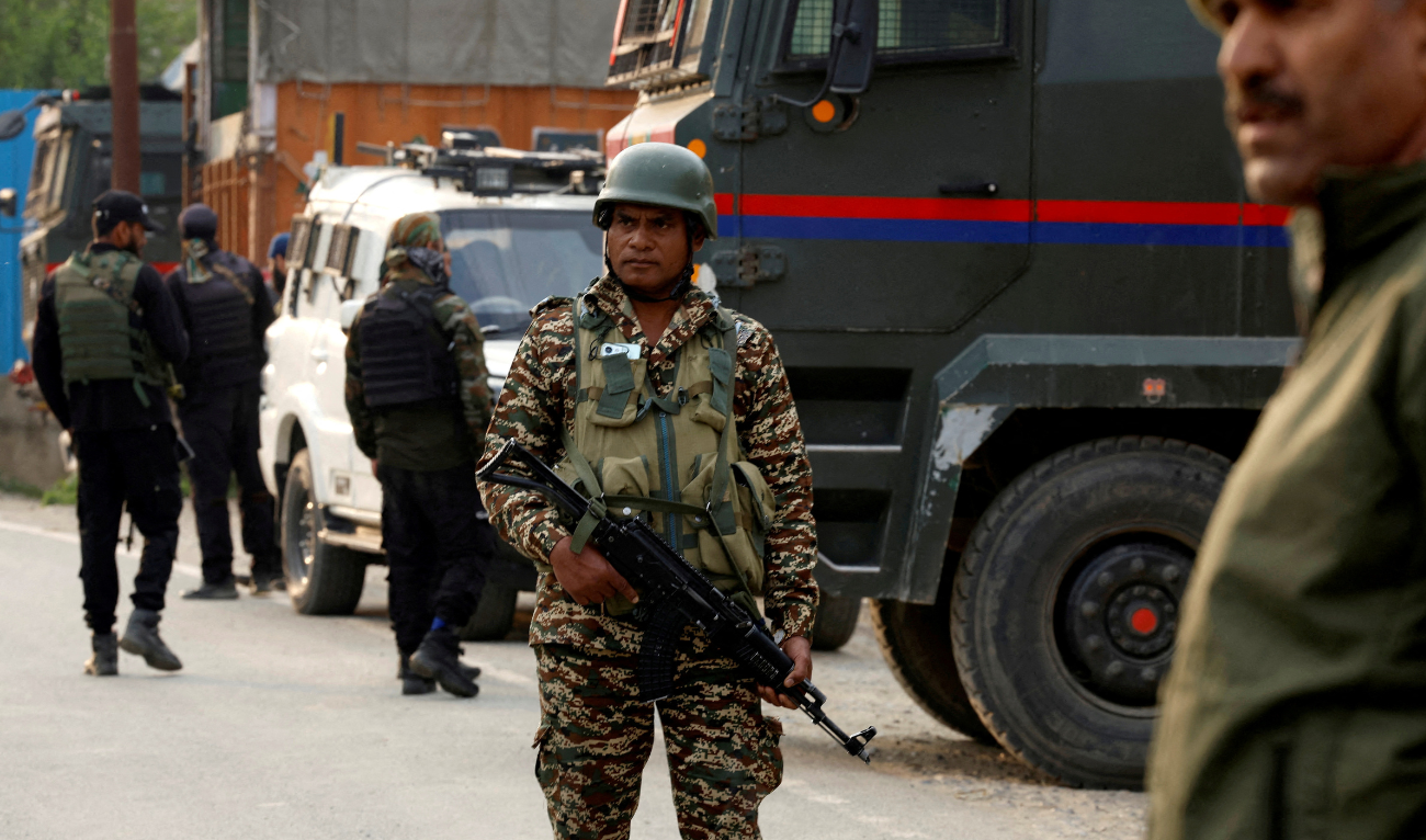 Indian security force personnel stand guard near the site of a fighter jet crash in Wuyan in India-administered Kashmir's Pulwama district, May 7, 2025. (REUTERS)