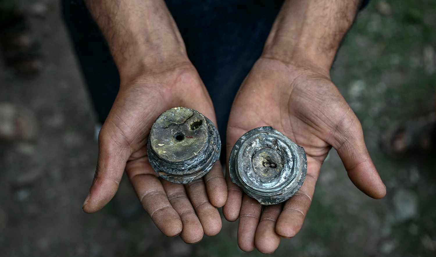 A resident shows remnants of mortar shells that exploded in Kalgi village in Uri, about 125kms from Srinagar in Indian-administered Kashmir, on May 8, 2025. (AFP)